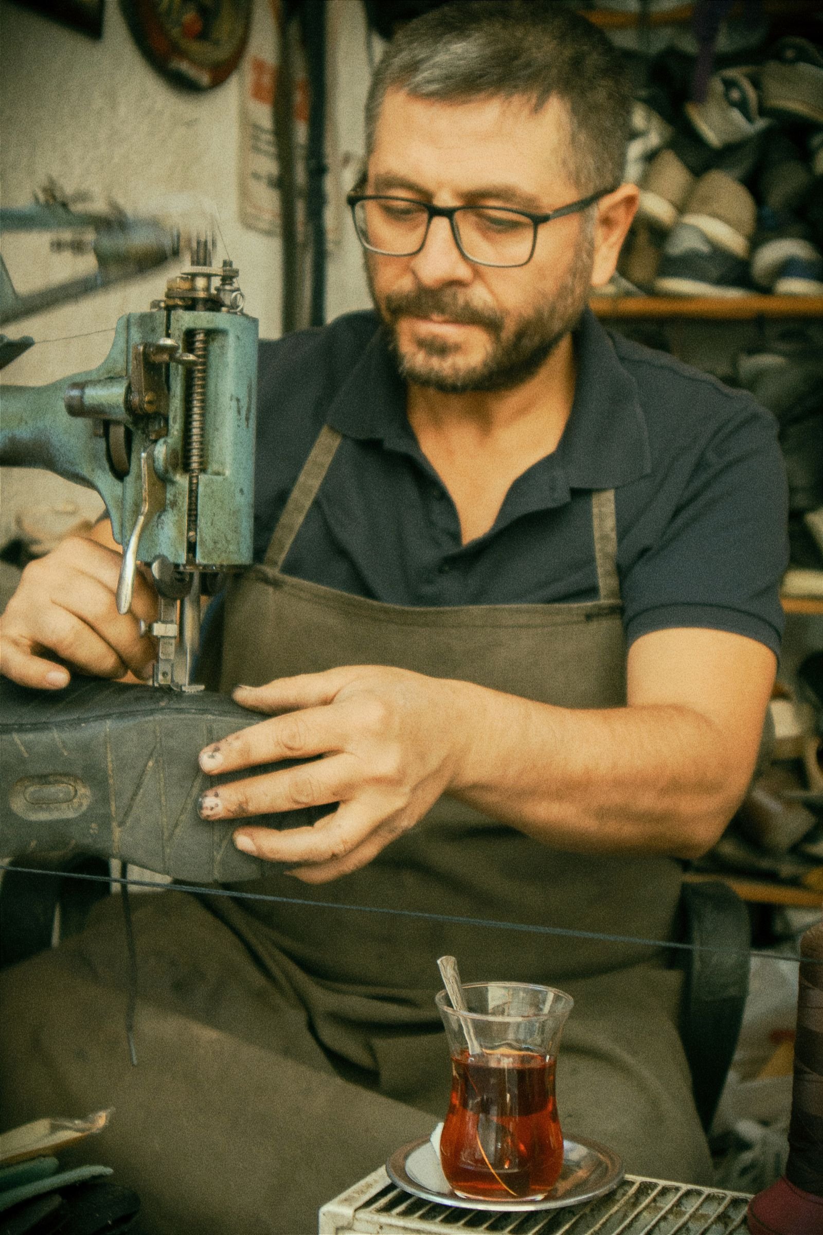 Cobbler repairing a leather shoe in a workshop